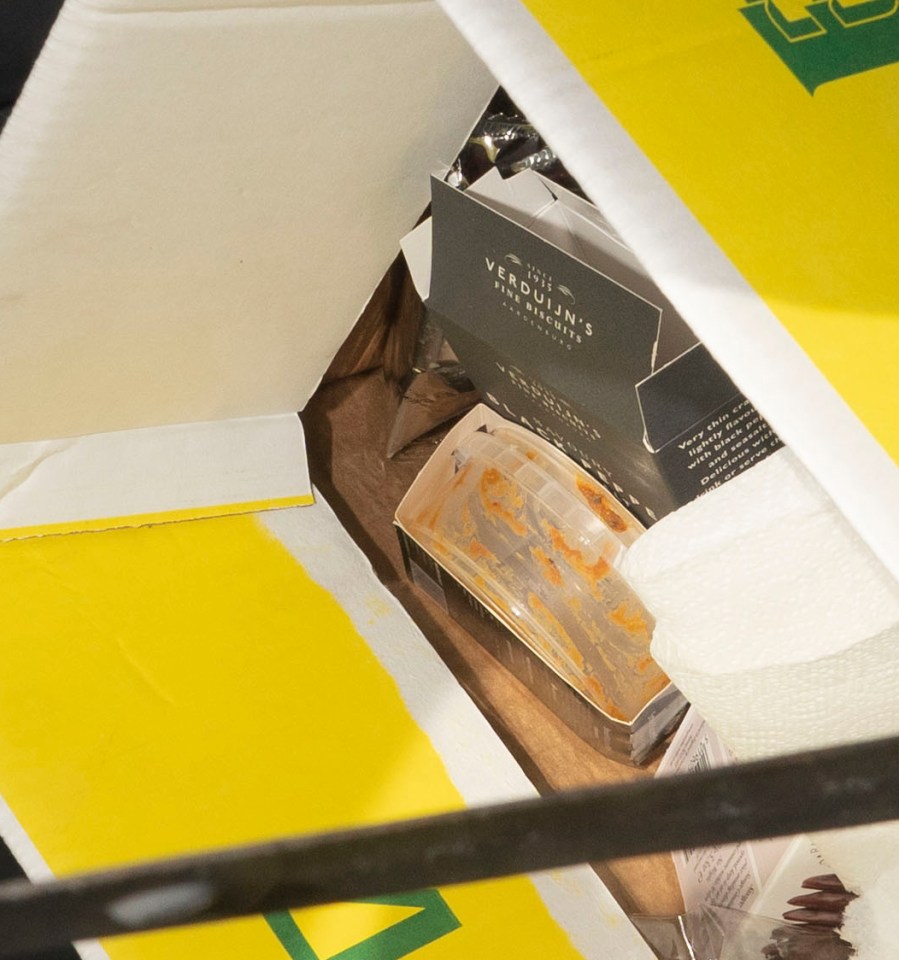  An empty box of luxury Dutch cheese crackers and dip pot inside a cardboard box