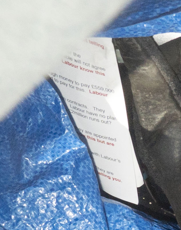  A political leaflet is poking out of an Ikea bag on the floor