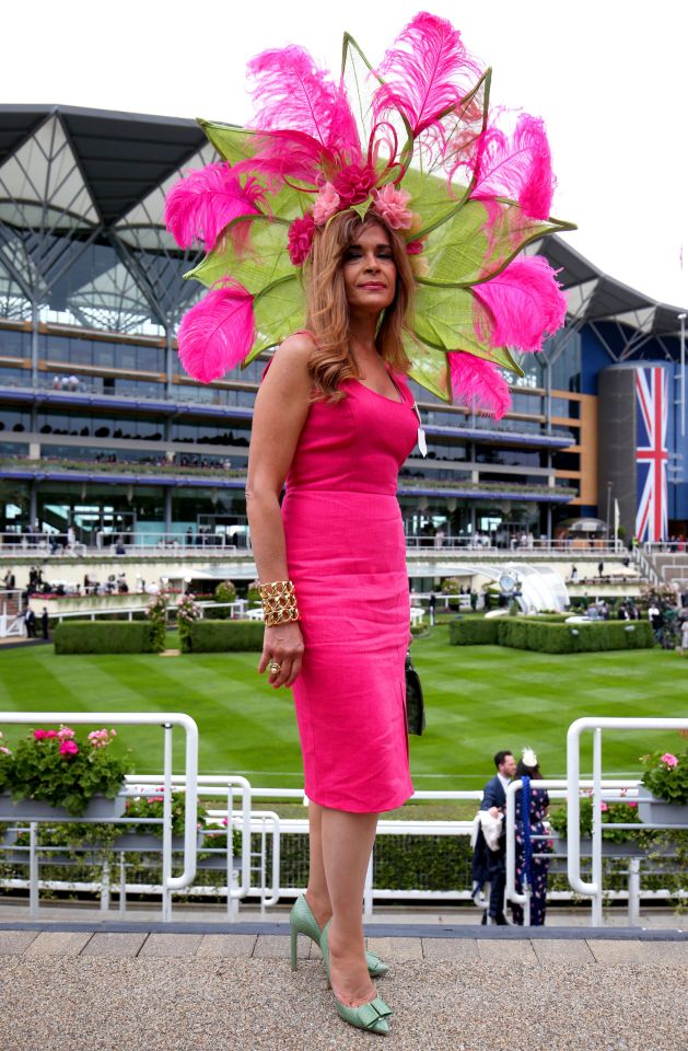 Ines Hernandez from the Dominican Republic wears a massive feathered hat made to look like a giant flower