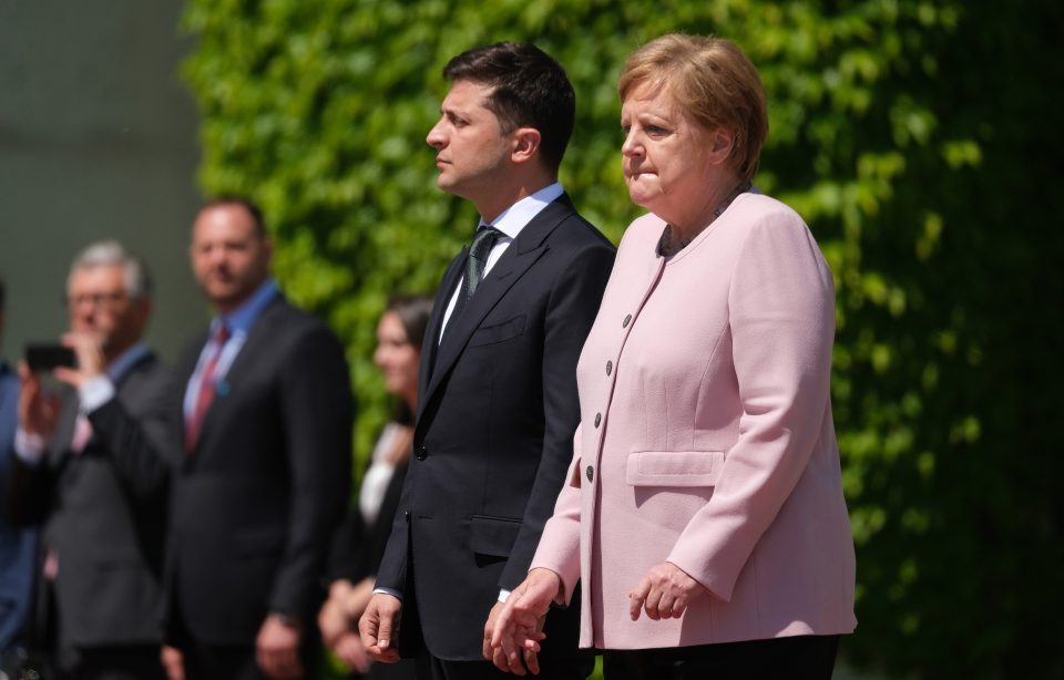  The two politicians were stood side by side during the military band's rendition of the national anthem