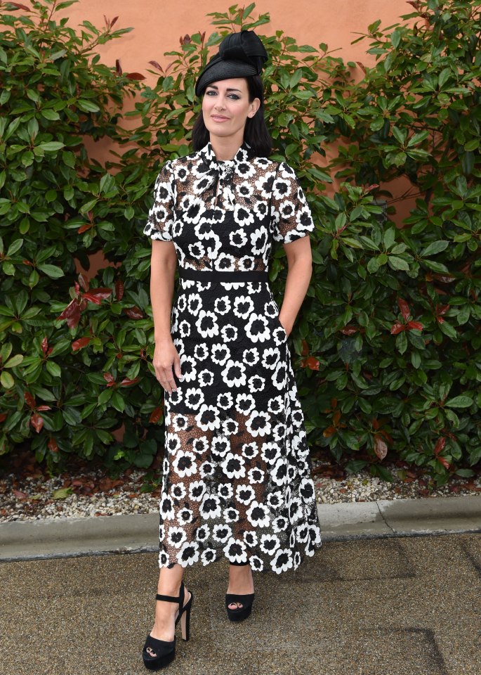 Kirsty Gallagher wears a sheer black and white dress paired with black heels and a black fascinator