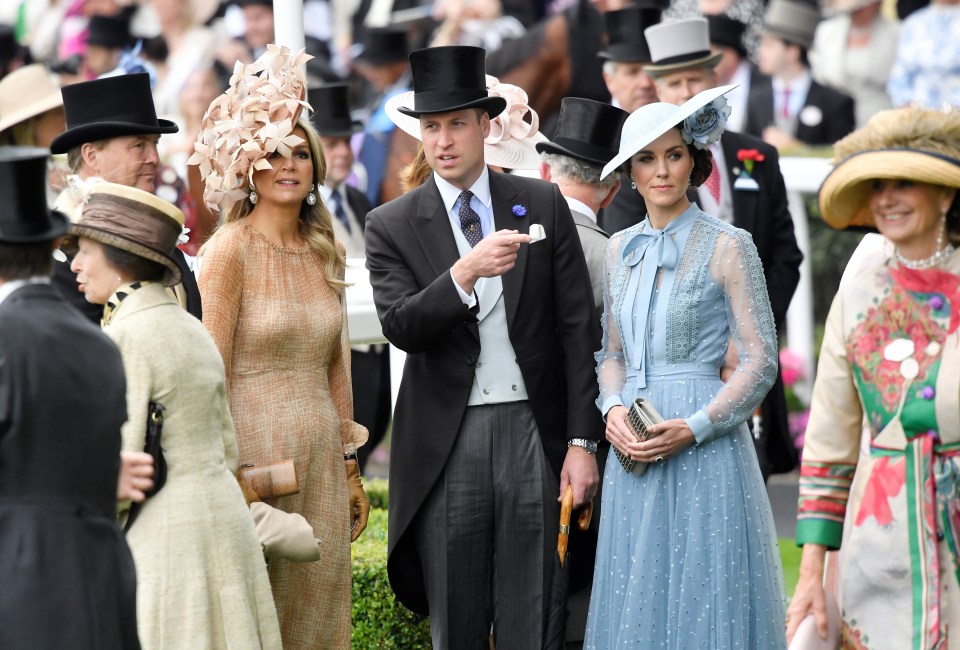 Prince William appears to point to the crowds while with Kate and Queen Maxima