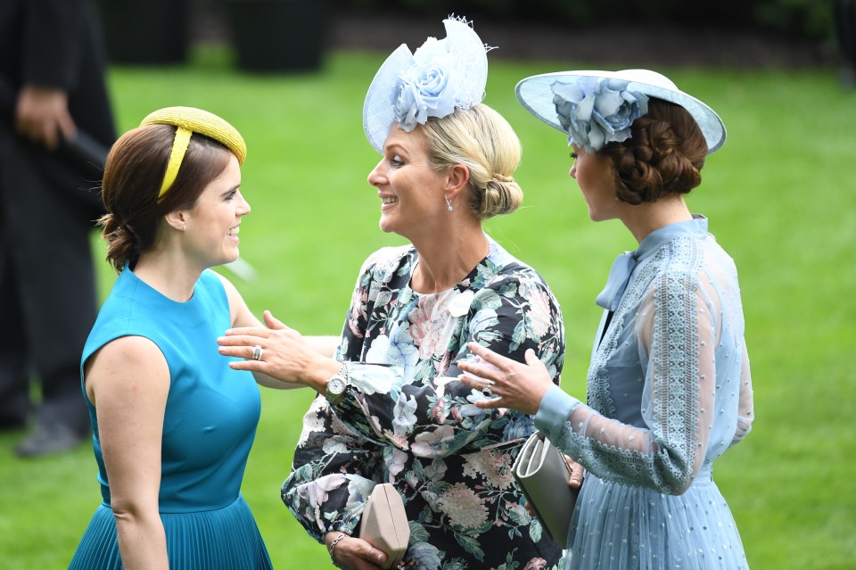 Zara smiles warmly at Princess Eugenie while they chat with Kate