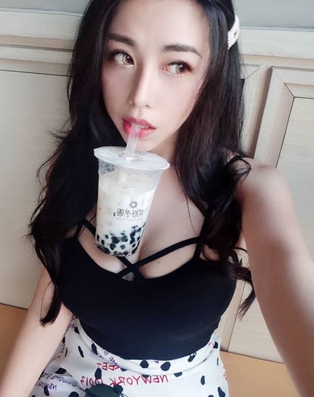 Japanese girls taking selfies with a carton of  bubble tea nestled between their baps is the latest craze