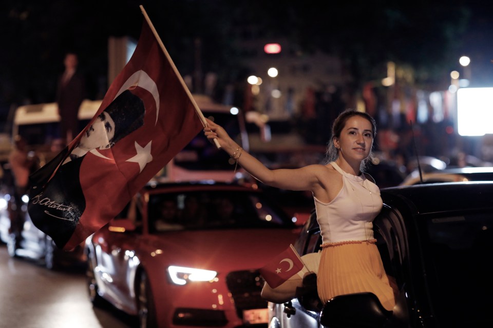  A supporter of Imamoglu waves a Turkish flag amid mass celebrations in Istanbul last night