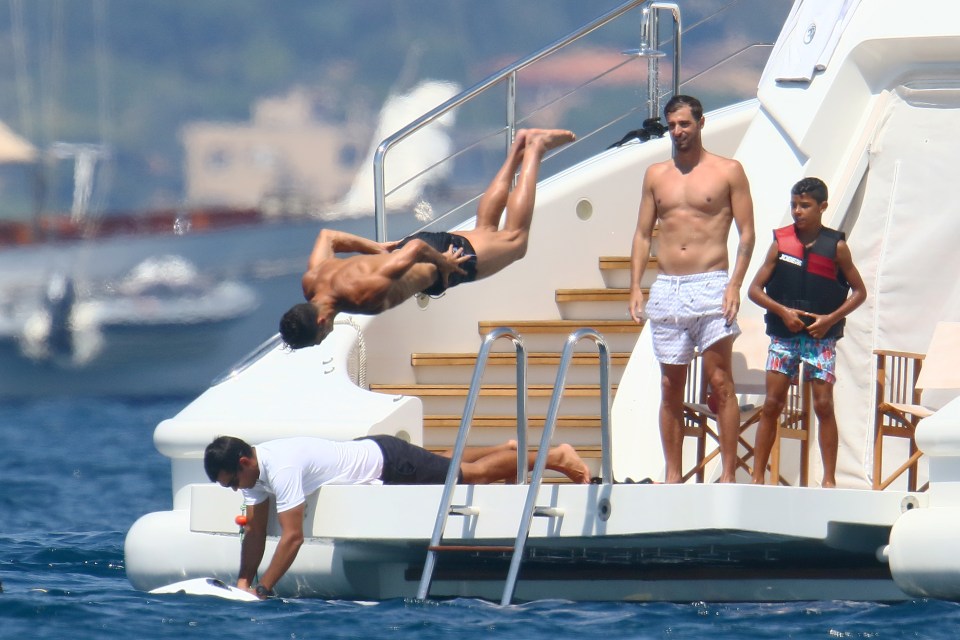  Cristiano Ronaldo pictured doing a flip off his £180,000-a-week yacht in the south of France