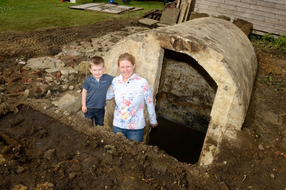  Kelly Webb and her son Riley with the Anderson style shelter they uncovered