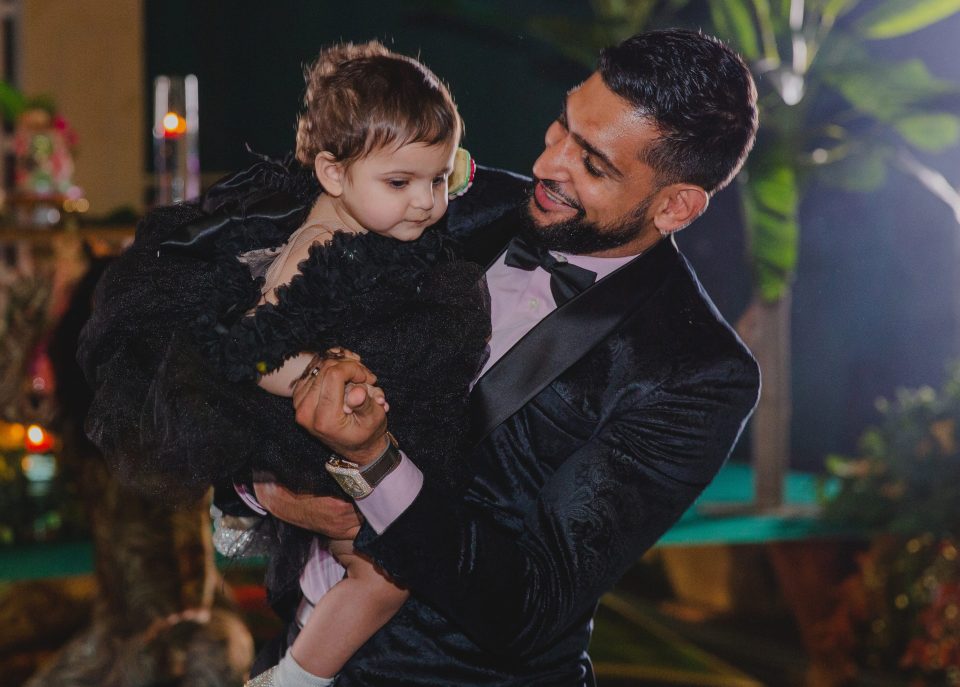  Amir cradled his youngest daughter at her party, months after her birthday in April