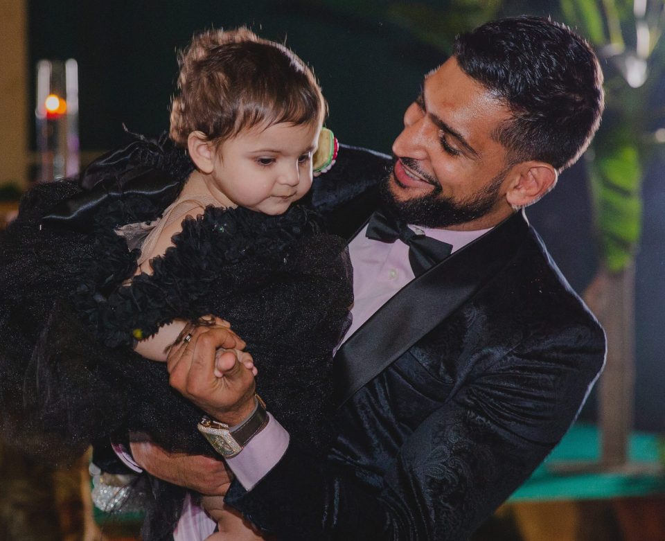  Amir cradled his youngest daughter at her party, months after her birthday in April