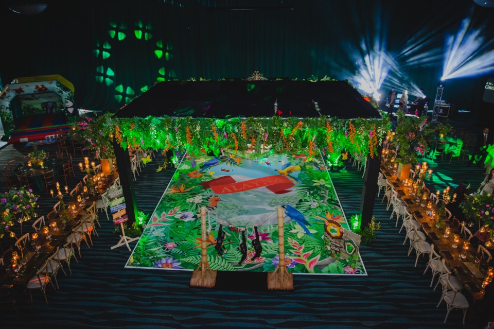  Multi-coloured butterflies and birds hung from the flower ceiling while long tables lined the dancefloor