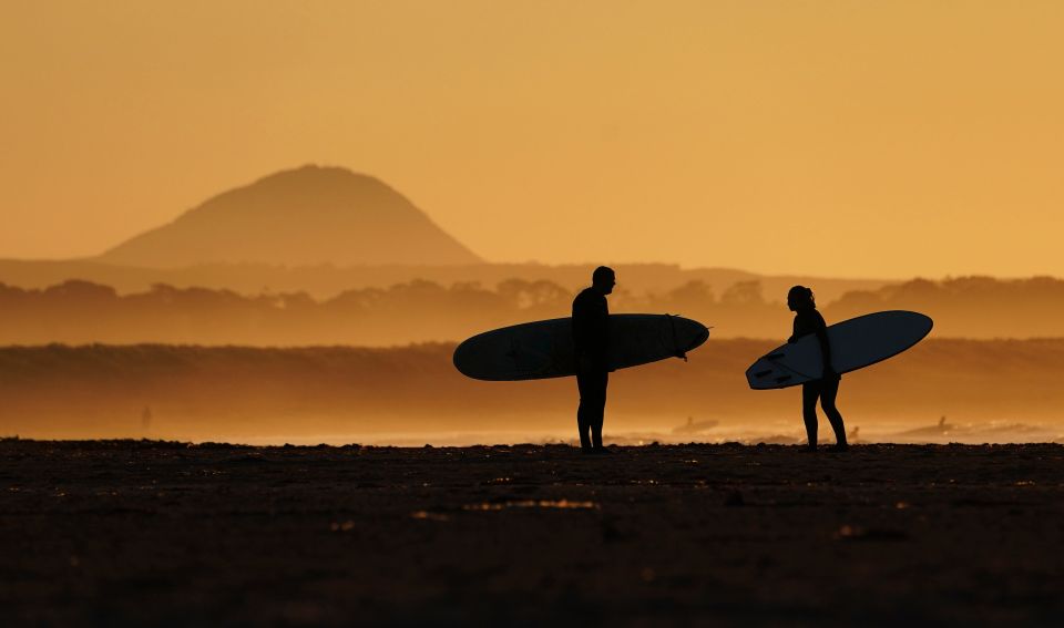 Surfers on Belhaven beach near Dunbar, Scotland hit the waves on June 26