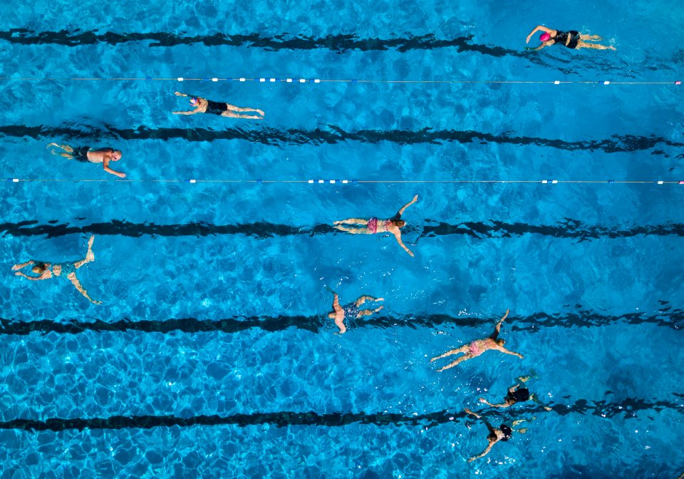 Swimmers take advantage of today's weather forecast as they take a dip in an open air pool