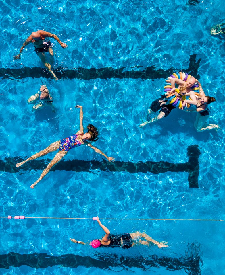 Swimmers enjoying a warm day at Gourock Pool on the banks of the River Clyde in Scotland