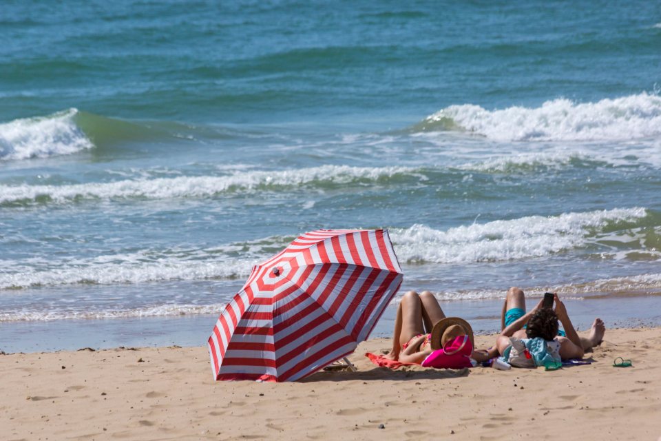 Beach-goers lay out on the sand in Bournemouth