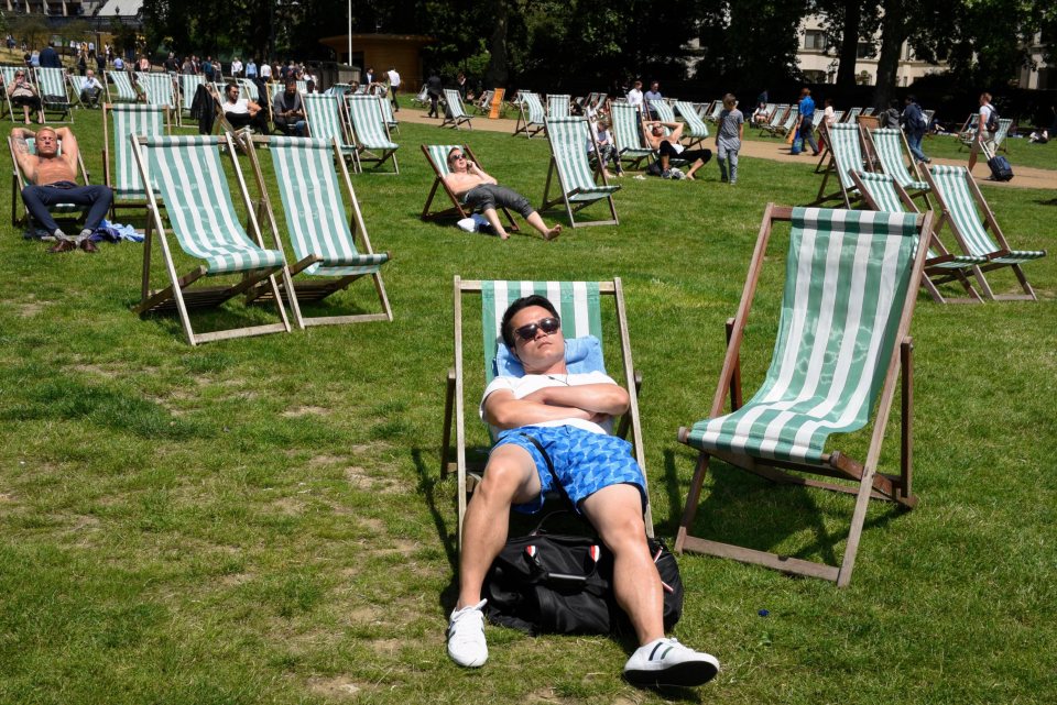 This man takes an afternoon kip during lunchtime in Green Park, London