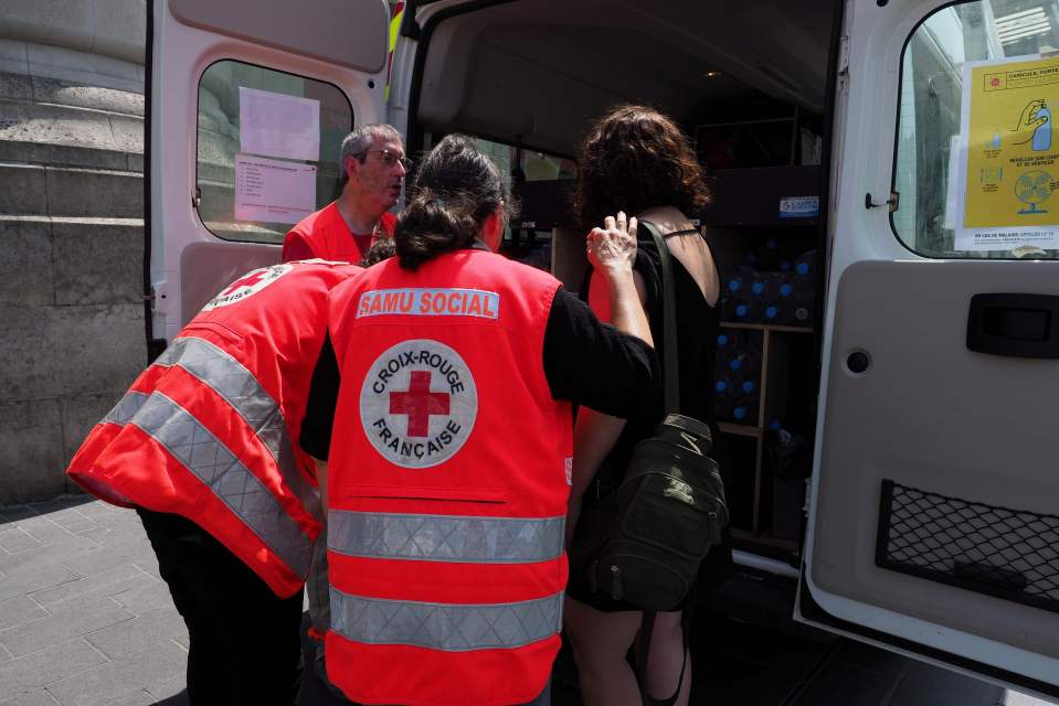  The French Red Cross assists a woman in front of the main train station of Tours