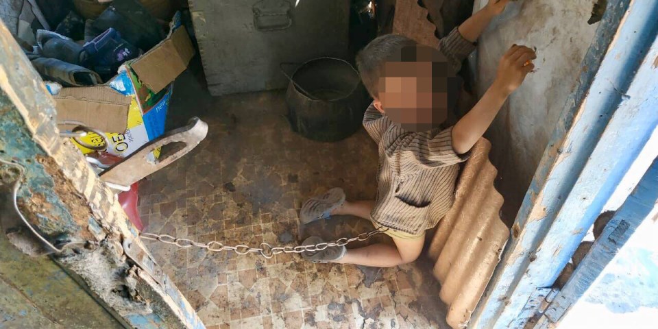  The shocking moment that police found the abused boy, chained and forced to kneel in his evil parents' home in Ukraine