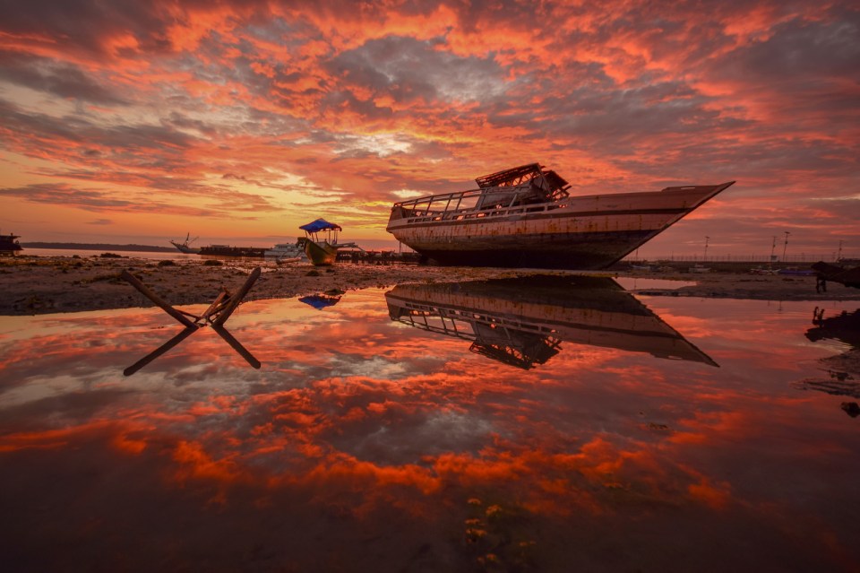  The dazzling sky as well as this abandoned boat are caught in this bold image by Apriandi