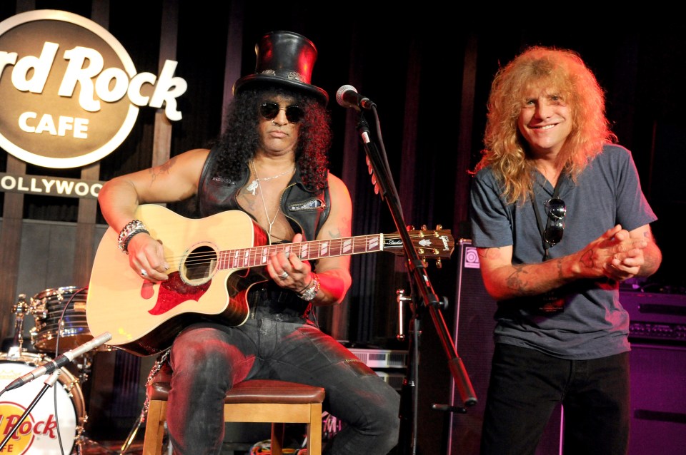  Slash, left, and Steven Adler perform at the Hard Rock Cafe on July 10, 2012 in Hollywood, California