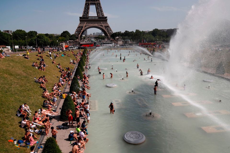  People bathe in the Trocadero Fountain near the Eiffel Tower in Paris during today's heatwave