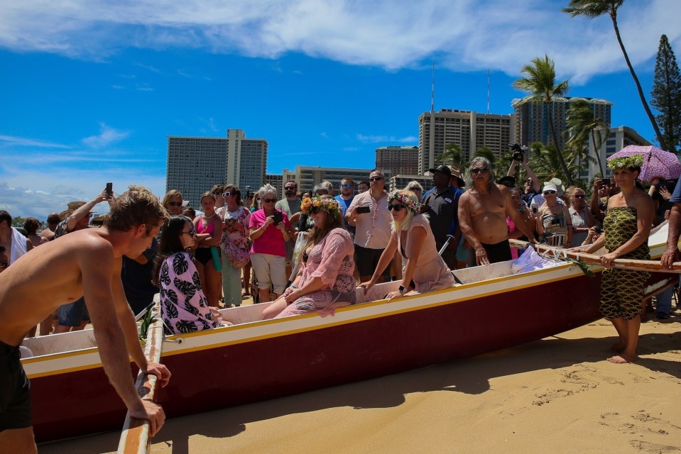 The memorial was a 'paddle out' where mourners go in to the sea and lay a wreath of flowers in to the ocean