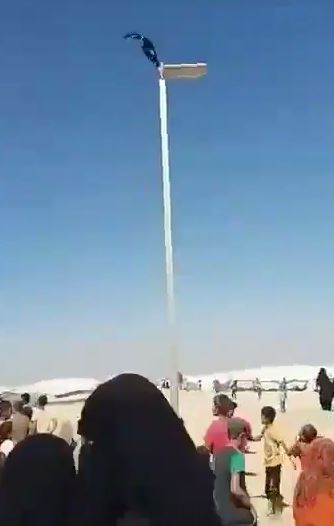  A video was shared showing an IS flag being hoisted above the camp