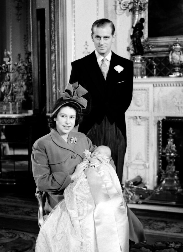  Queen Elizabeth and Prince Philip pose with Prince Charles after his christening in 1948