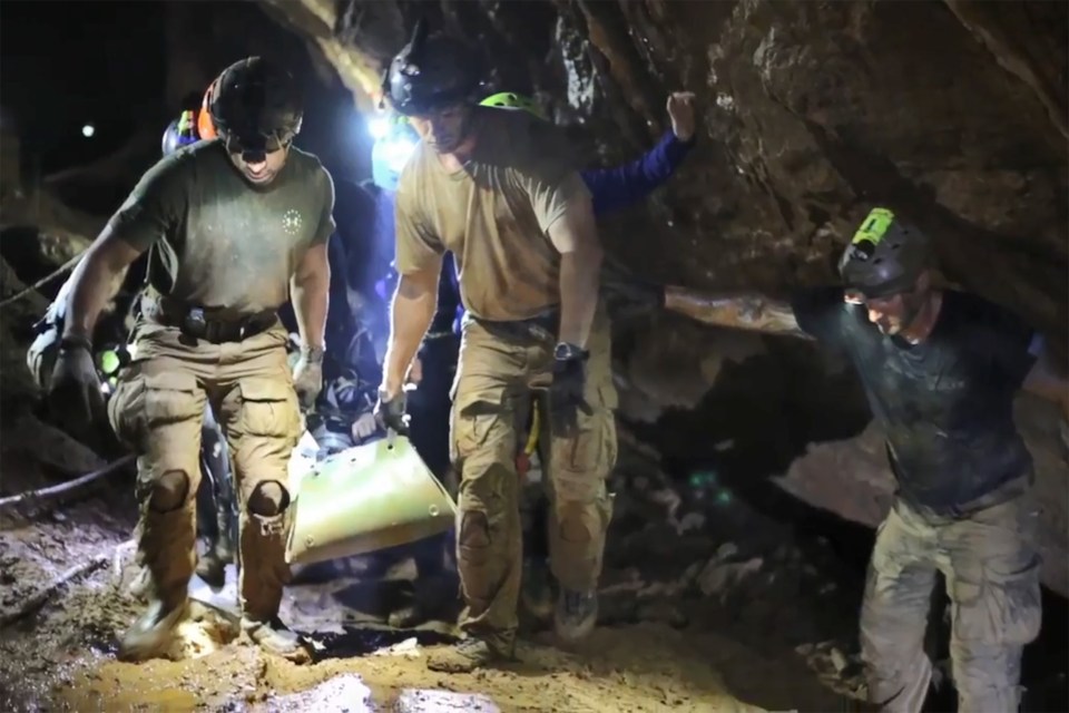  Rescuers carry one of the stricken boys on a stretcher last year