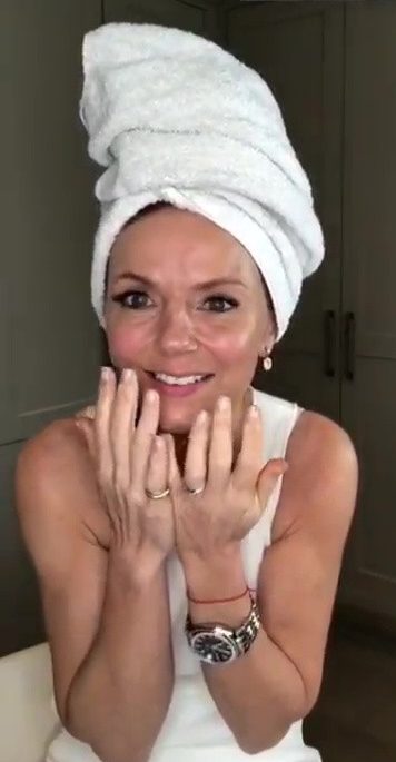 Geri wears a white towel while at home