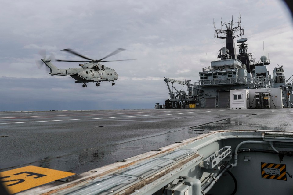  A Merlin helicopter brings in some Royal Marines onto the deck of HMS Albion