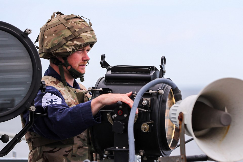  A sailor on HMS Albion signals to other ships during Baltic Protector