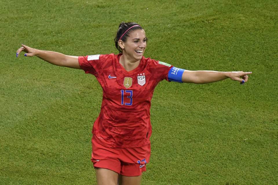  Alex Morgan celebrates as she scores against England