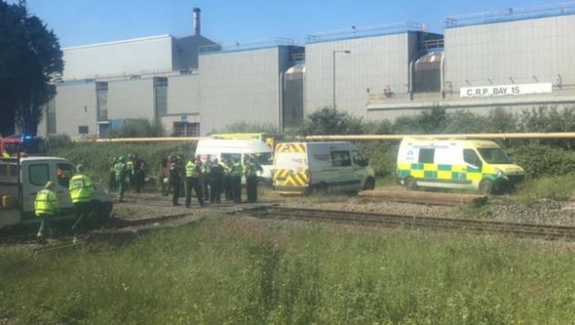 Police at the scene where two people were killed after being hit by a train in Wales today