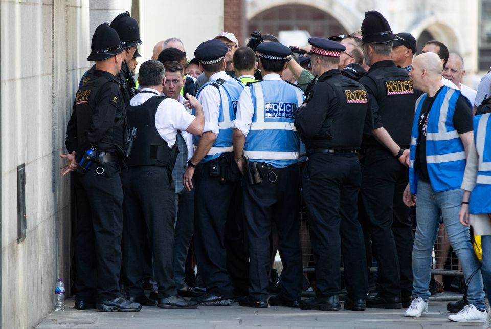  Police officers swarmed around Robinson as he made his way to the Old Bailey