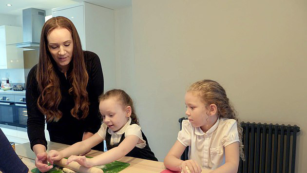  Mel with her two daughters in the kitchen of the renovated home