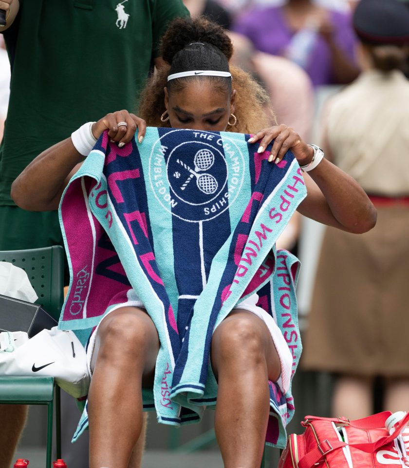 Serena Williams looks at one of the inspirational messages she writes to herself under her towel