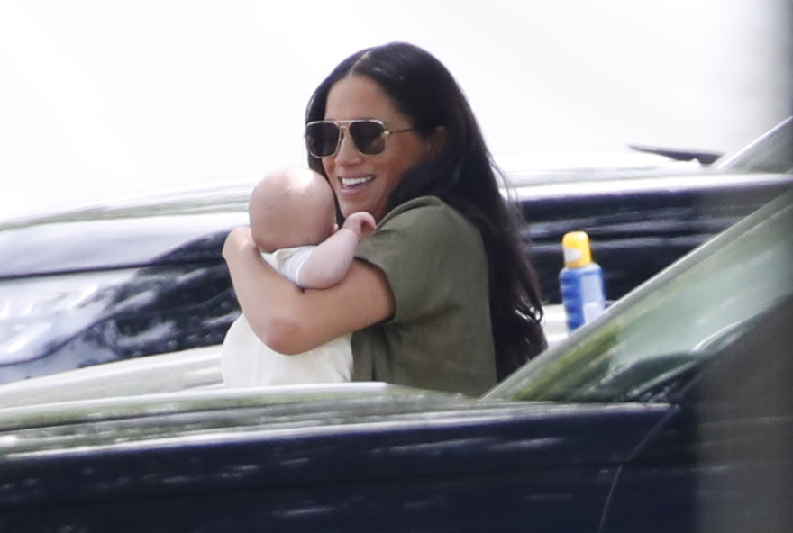 The 37-year-old beams with her little boy in her arms