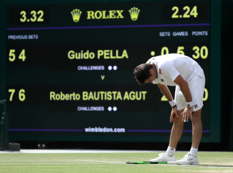 Guido Pella drops his racket in frustration during the match