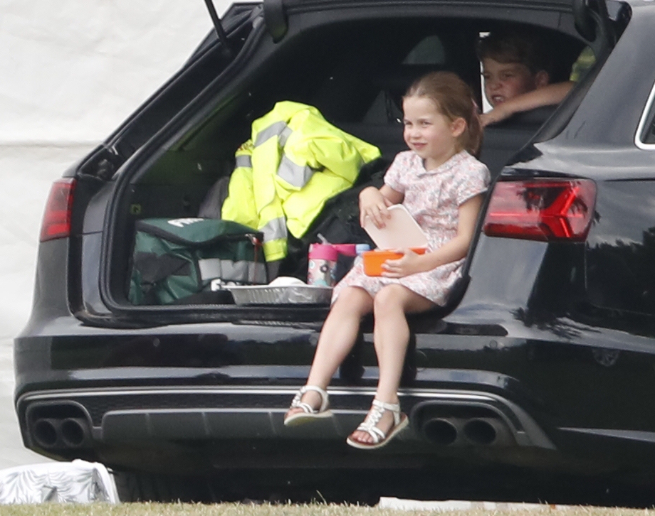 Princess Charlotte tucks into a packed lunch in the back of the car