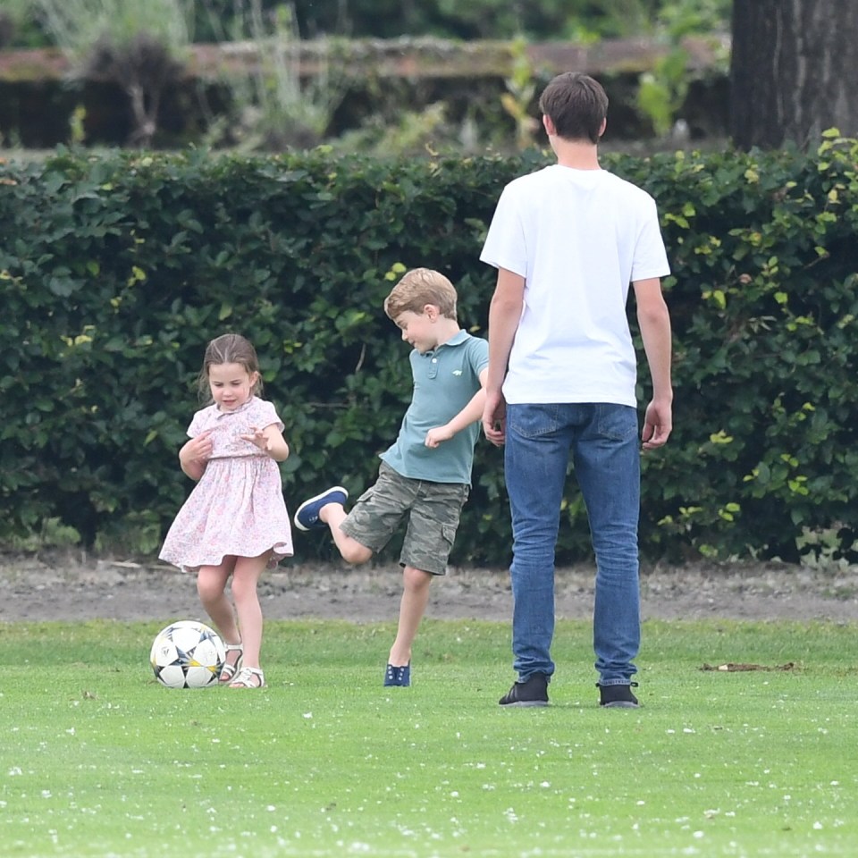 Princess Charlotte kicks a football around with her older brother