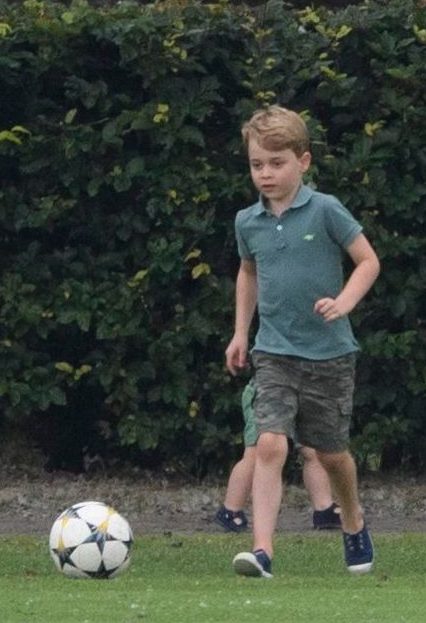 Prince George takes a run up for the ball