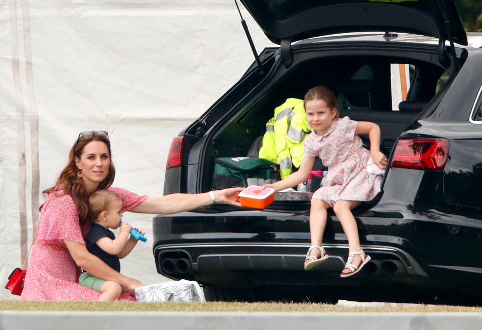 Kate passes a packed lunch to Charlotte