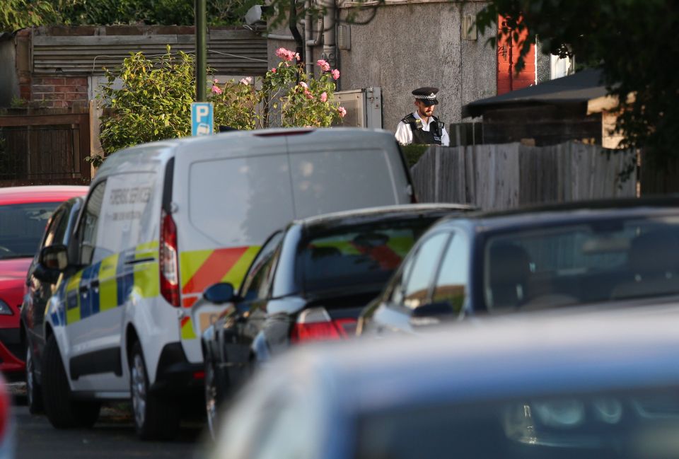  Police outside a property where an elderly man and woman were found with their throats slit