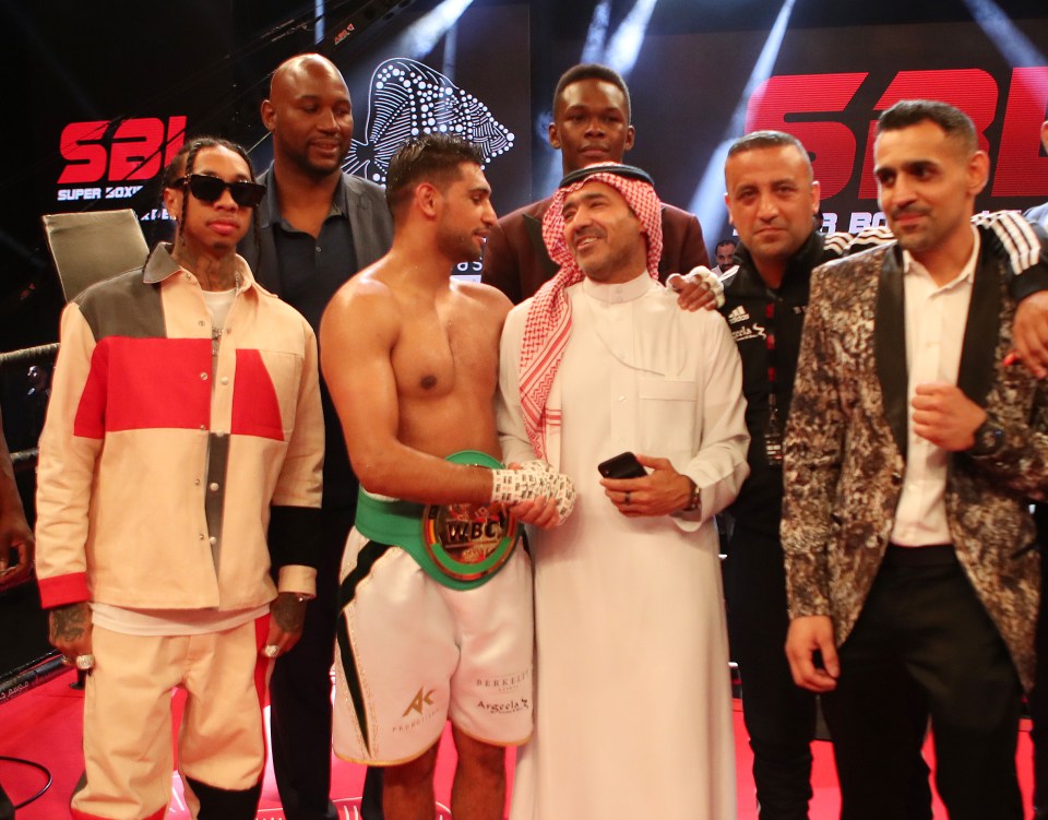 Amir Khan had rapper Tyga (left) on the mic on his ringwalk, and the musician celebrated in the ring with the boxer