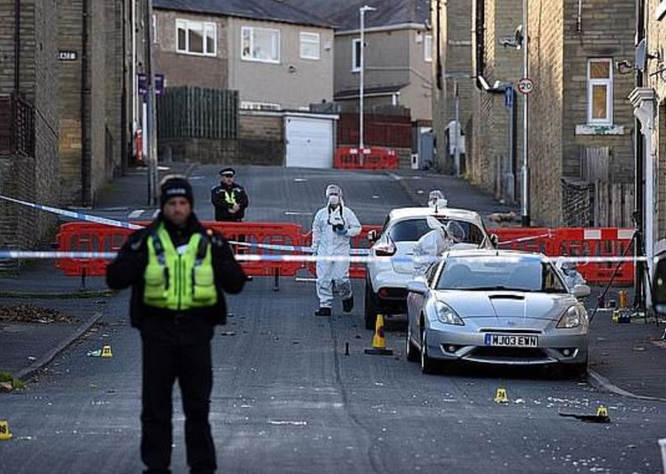  Police and forensics teams are pictured searching the area the day after the fatal attack in Ovenden, West Yorkshire