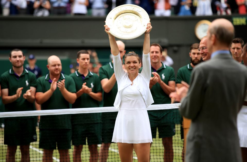  Simona Halep lifts the Wimbledon trophy aloft after thumping Serena Williams in the final