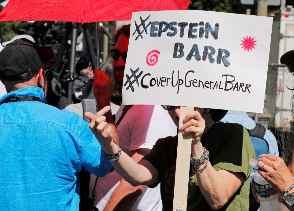 Protesters held up signs and banners outside the courtroom today