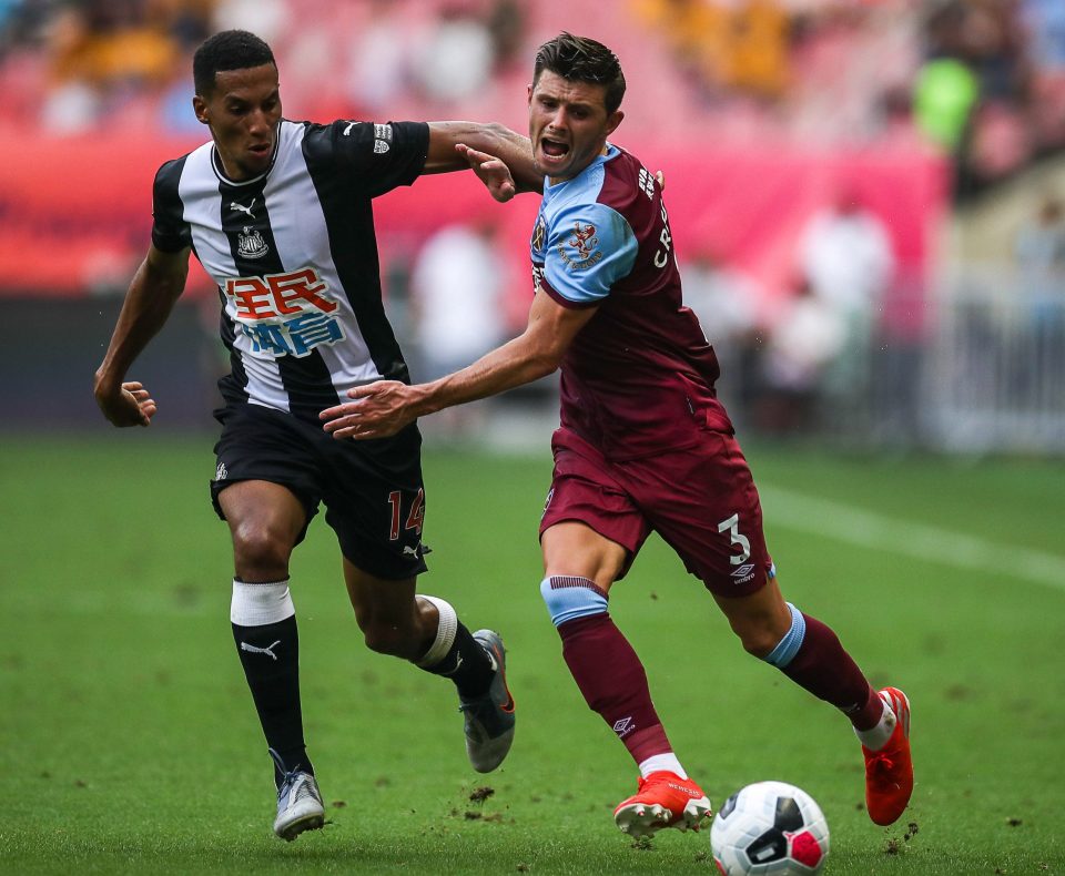 Isaac Hayden battles with Aaron Cresswell for the ball in Shaghai