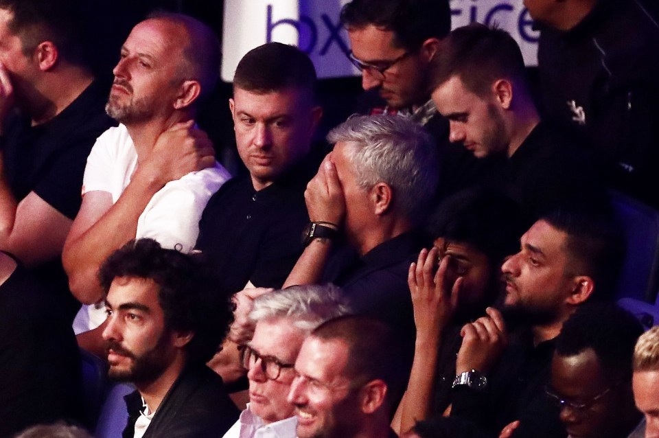 Jose Mourinho covers his face as he sat ringside in London