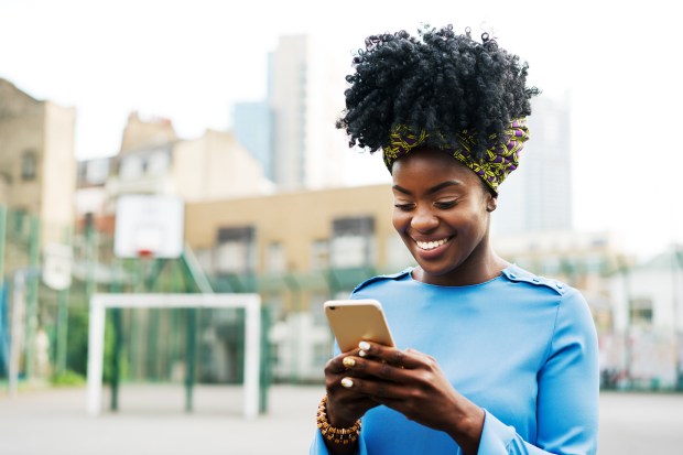 Woman using mobile in park